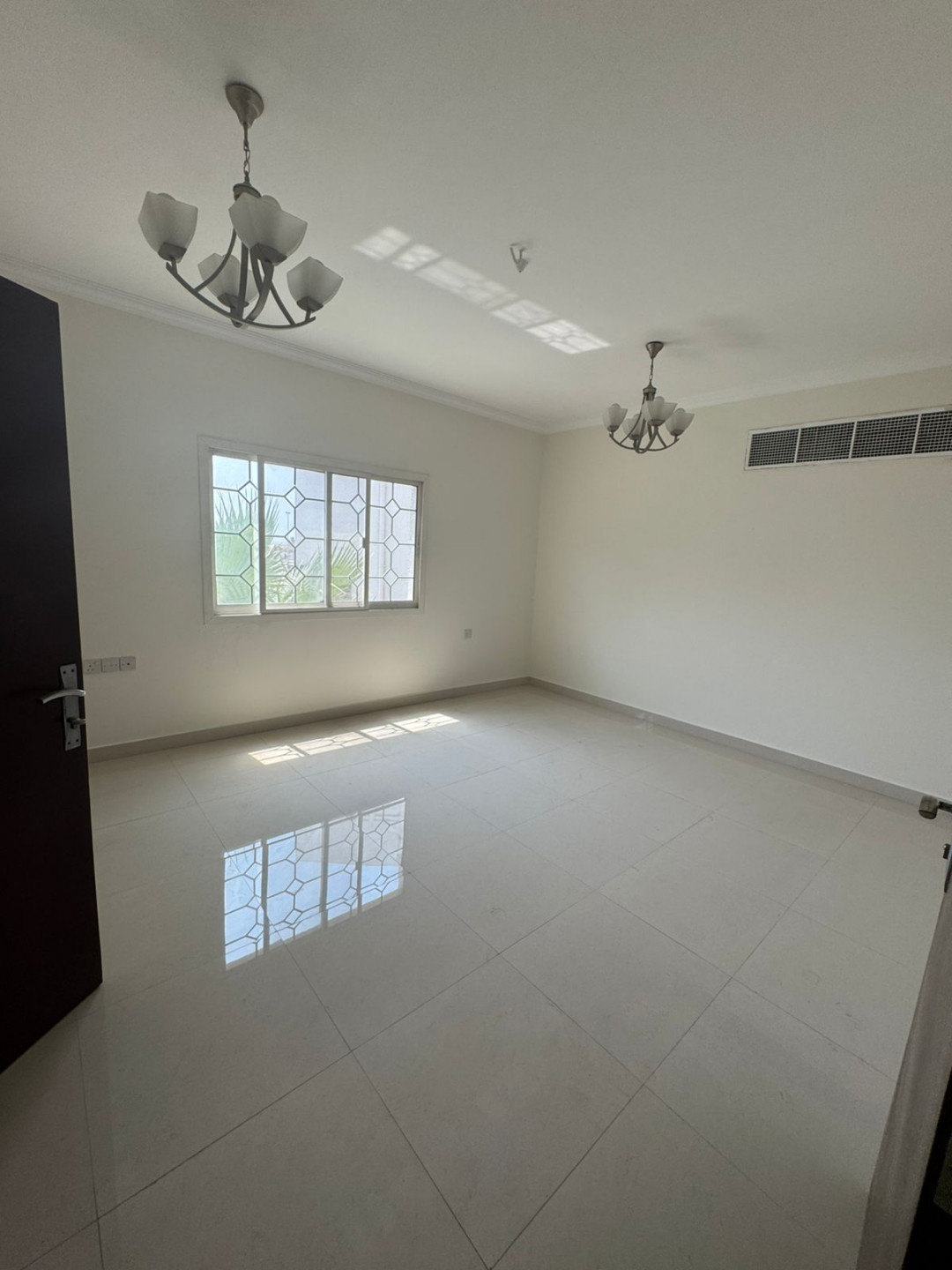 Luxury two-bedroom apartment with living room and majlis for annual rent in Sharjah, featuring a garden, kids' area, and sea view.