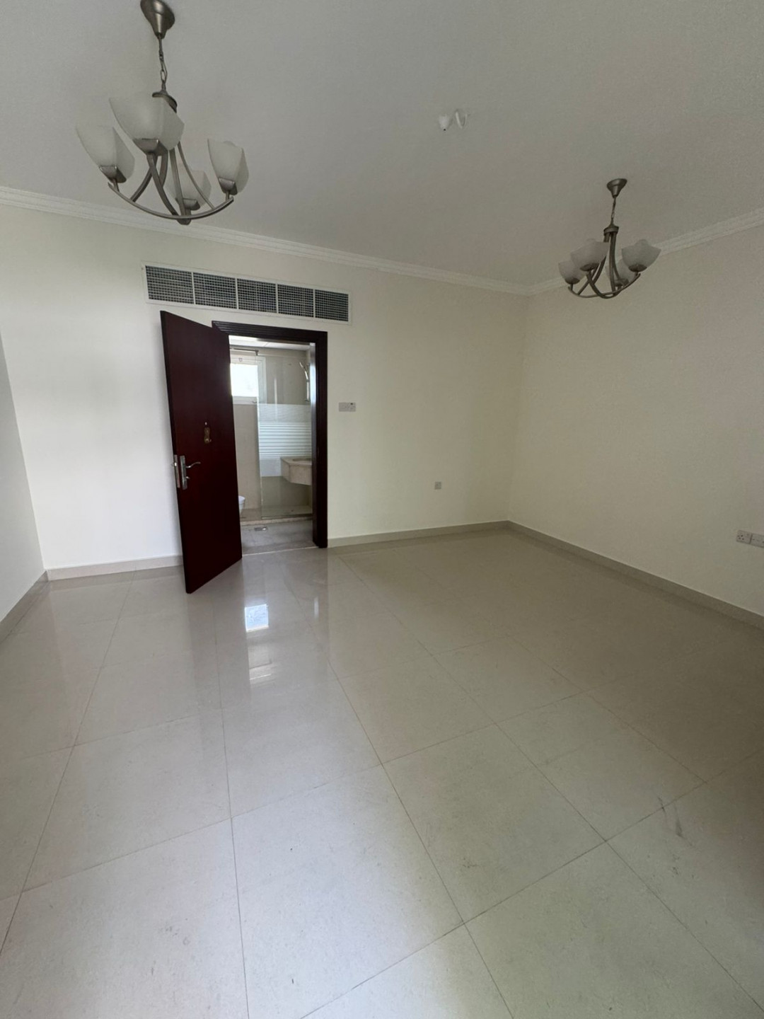 Luxury two-bedroom apartment with living room and majlis for annual rent in Sharjah, featuring a garden, kids' area, and sea view.