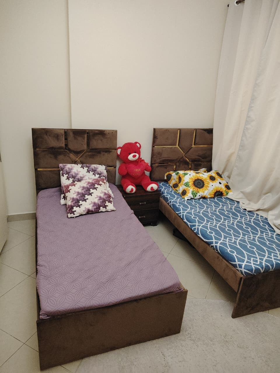 Two bedrooms and a living room, furnished with very clean furniture, and a bathroom.
