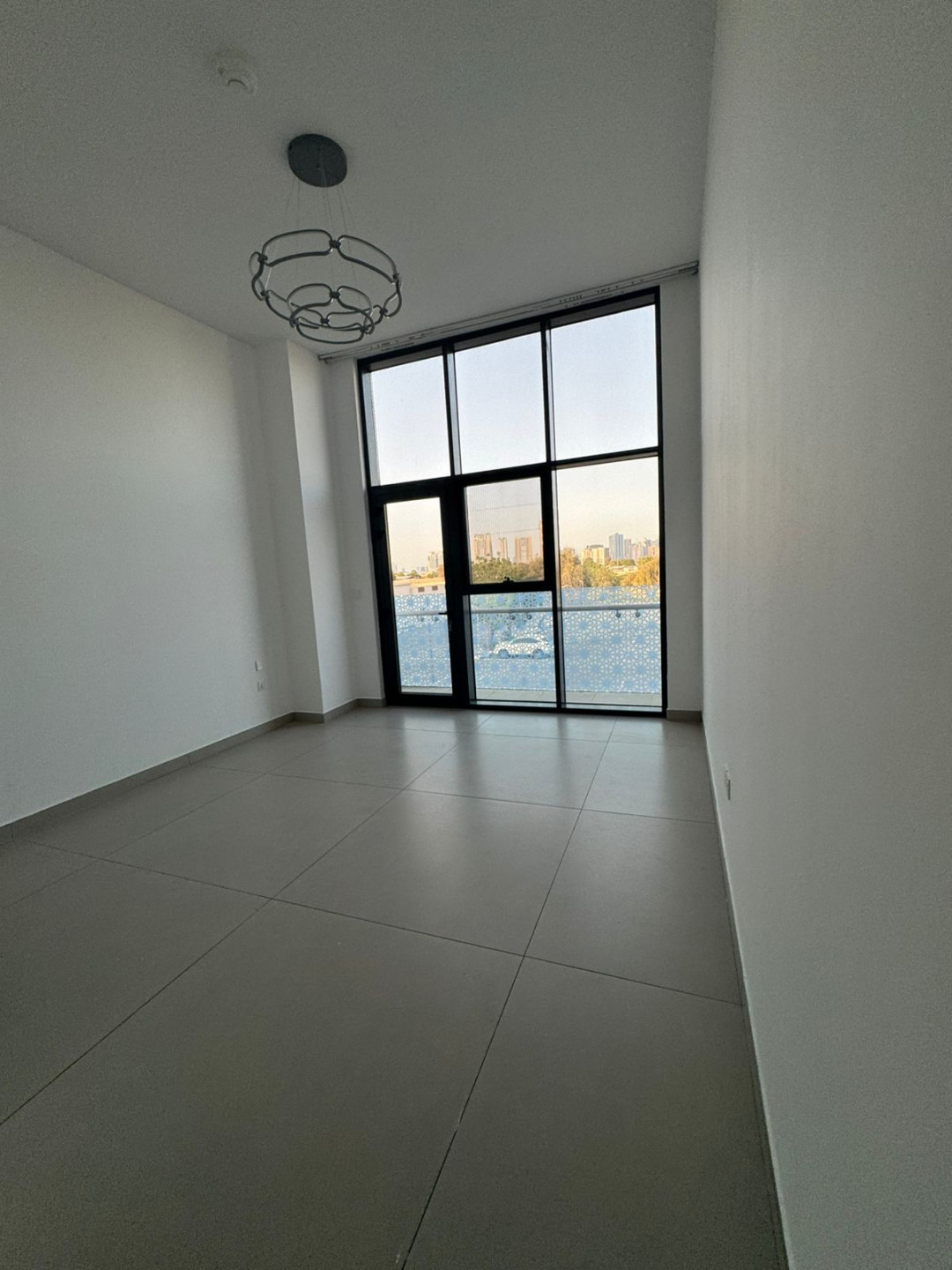 Three bedrooms and a living room for annual rent in Sharjah, with a maid's room, laundry room, gym, swimming pool, and two free parking spaces.
